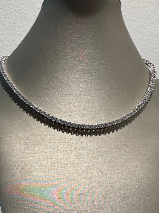 Close-up of a textured gray surface with a rainbow reflection